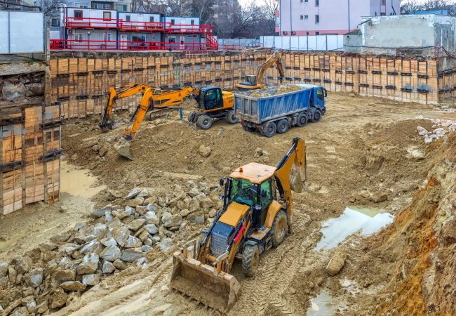 Heavy construction equipment working at the construction site.