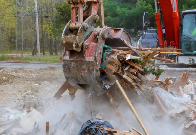 Debris being picked up from a house demolition